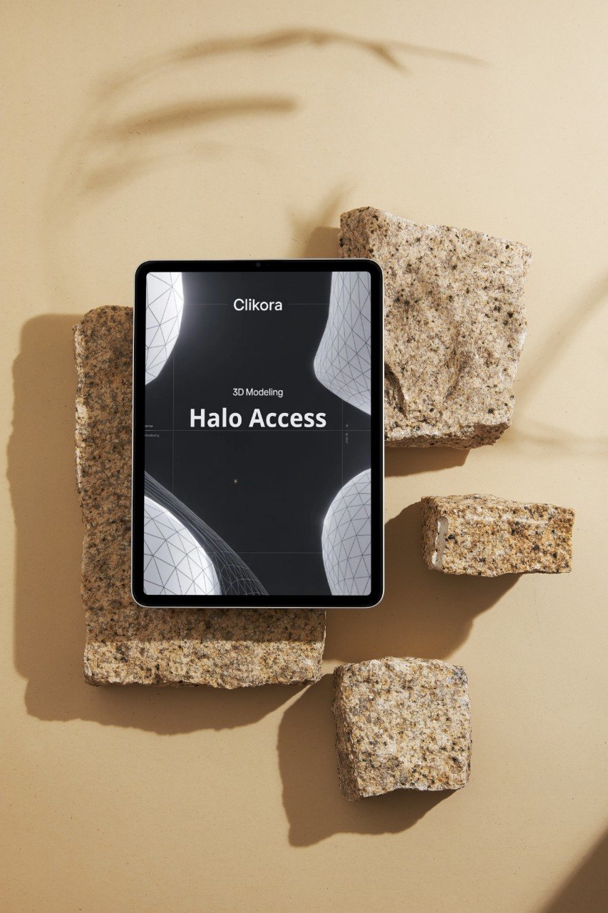 Tablet displaying 'Clikora Halo Access' on a beige surface with stone-like blocks.